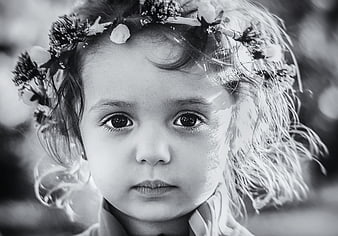 Black and white portrait of a young girl with a flower crown