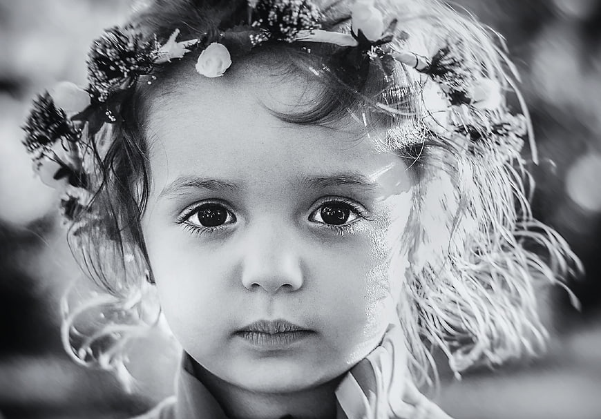 Black and white portrait of a young girl with a flower crown