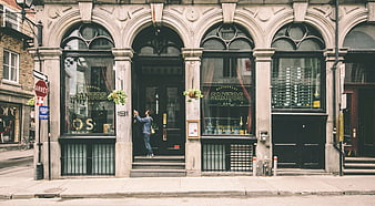 Man entering historic Santos restaurant storefront in Montreal