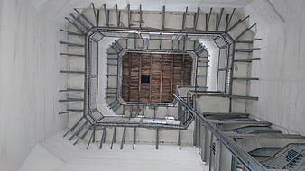 Looking down octagonal stone tower staircase interior