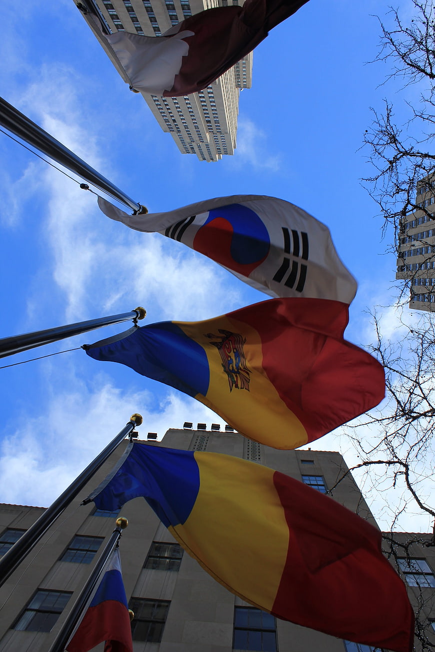 International flags waving against blue sky in New York City