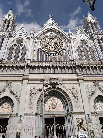 Low angle view of ornate Gothic cathedral facade with rose window