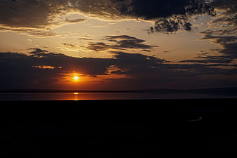Dramatic sunset over a salt lake in Turkey with dark foreground