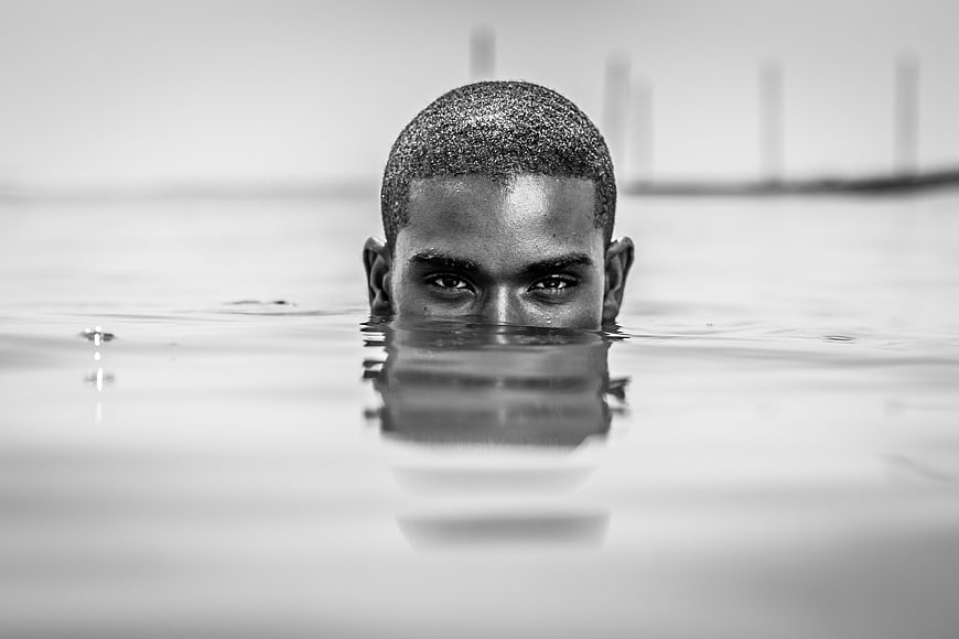 Black and white portrait of man submerged in water