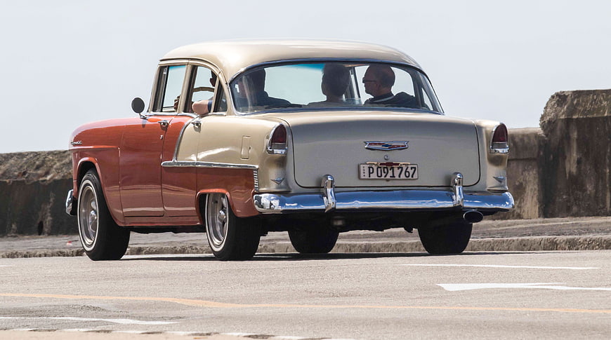 Vintage Classic Car Driving on Havana Malecon Road