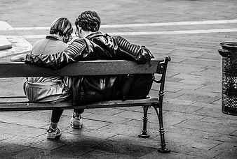 Couple Sitting on Bench from Behind in Black and White