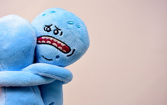 Two blue plush toys hugging with sad faces on beige background