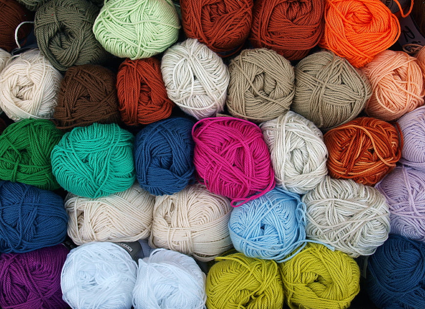 Colorful balls of yarn arranged in a grid pattern