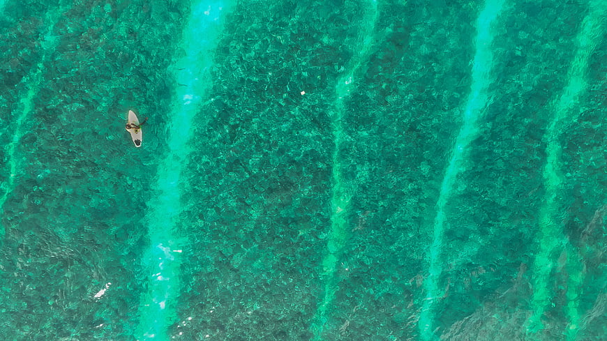 Aerial View of Surfer in Turquoise Ocean Water