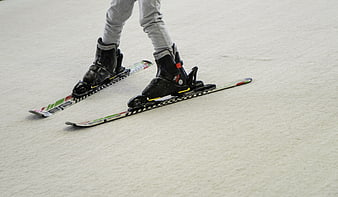Close-up of ski boots and skis on snow slope
