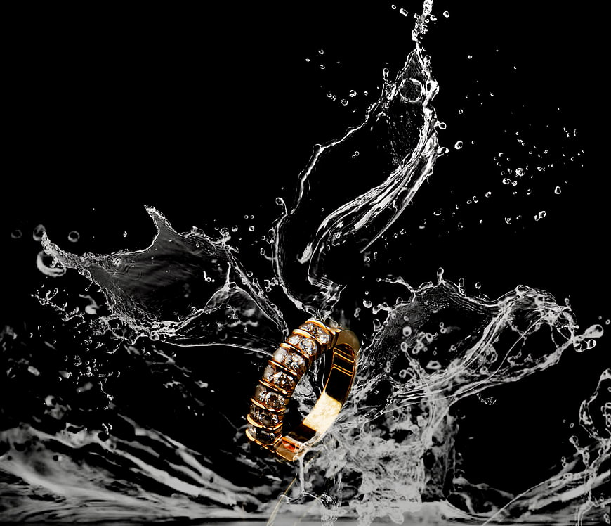 Gold Diamond Ring With Dynamic Water Splash On Black Background