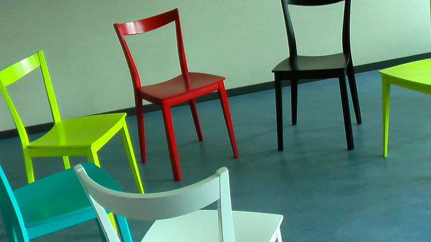 Colorful chairs arranged in a circle on blue floor