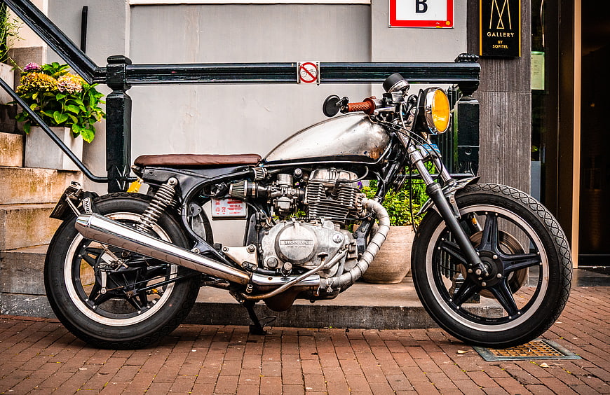 Custom Cafe Racer Motorcycle Parked on Brick Street