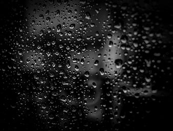 Black and white raindrops on glass window texture