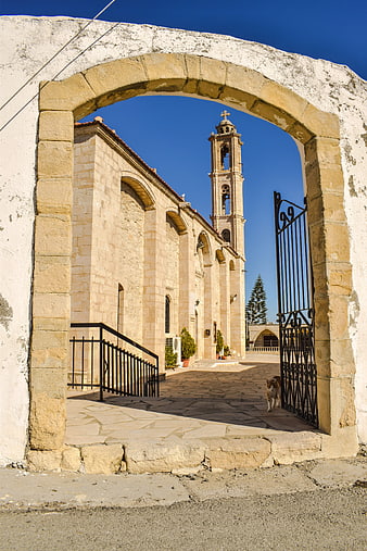 Stone archway framing historic church in Cyprus