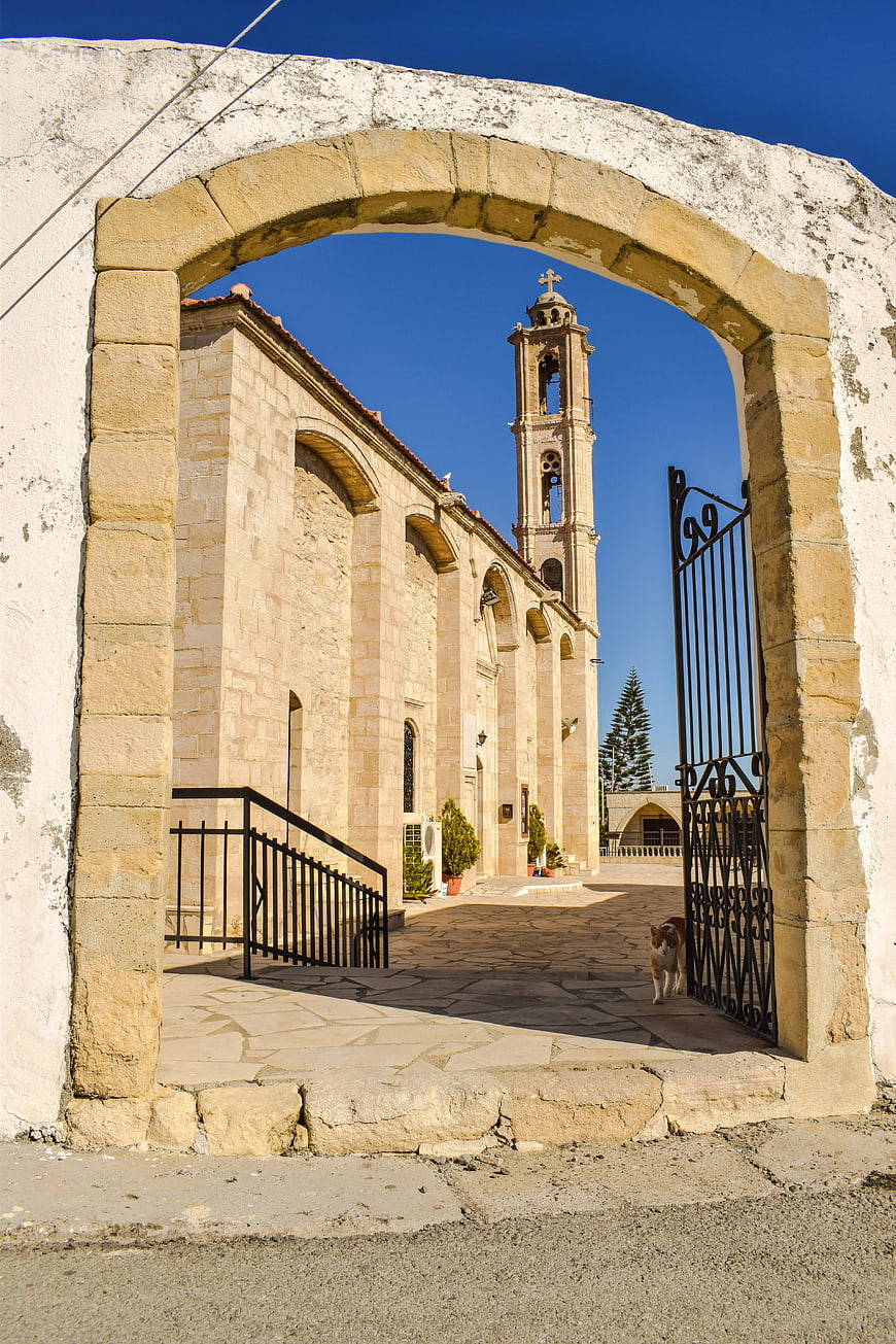 Stone archway framing historic church in Cyprus