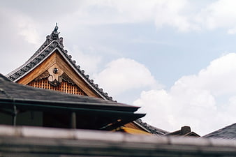 Traditional Japanese Temple Roof Against Cloudy Sky