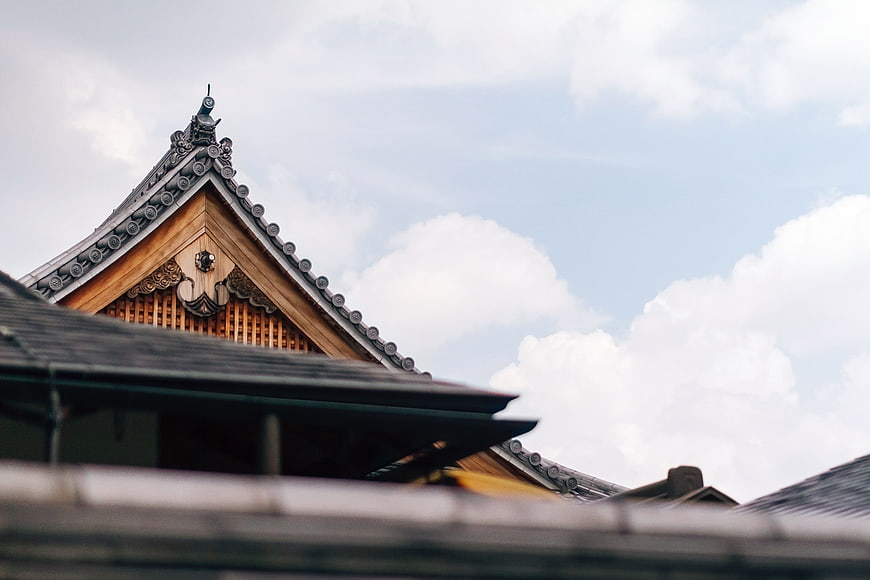 Traditional Japanese Temple Roof Against Cloudy Sky