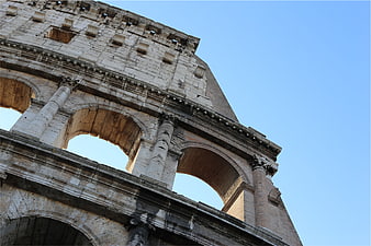 Low angle view of the Colosseum in Rome against blue sky