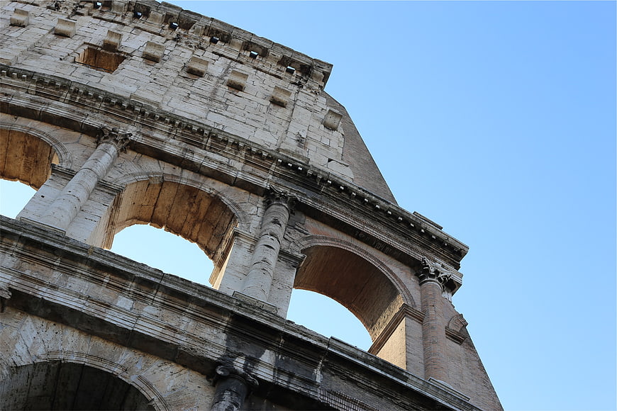 Low angle view of the Colosseum in Rome against blue sky