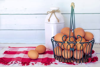 Fresh Brown Eggs in Wire Basket on Red Checkered Cloth