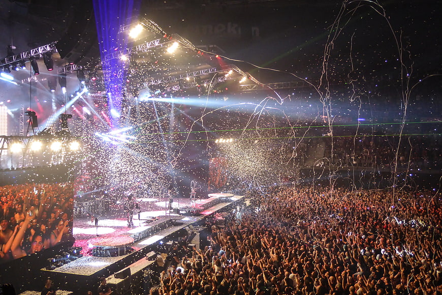 Rock concert stage with confetti and cheering crowd