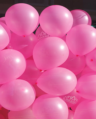 Close-up cluster of glossy pink party balloons