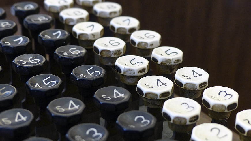Close-up of vintage mechanical adding machine keys with numbers