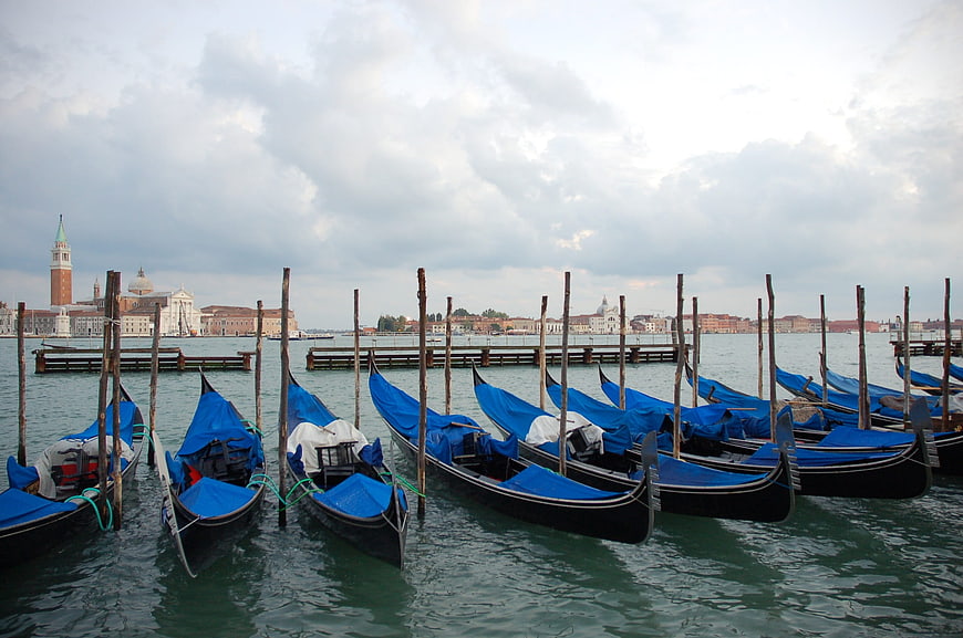 Gondolas docked in Venice lagoon with San Giorgio Maggiore