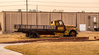 Vintage Rusty Flatbed Truck in Industrial Yard