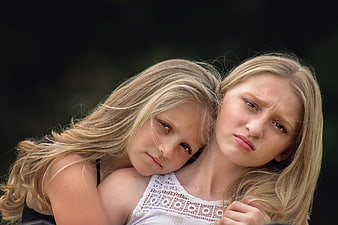 Sad Young Girls Hugging with Emotional Expressions