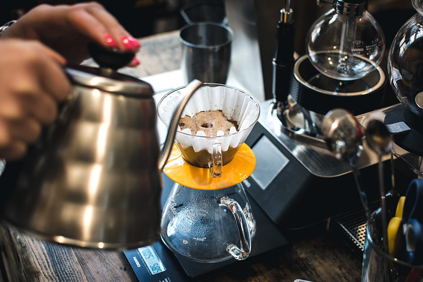 Barista Pouring Hot Water into V60 Coffee Dripper