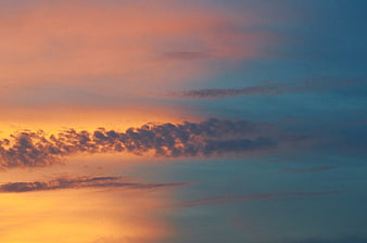 Colorful sunset sky with orange and blue clouds