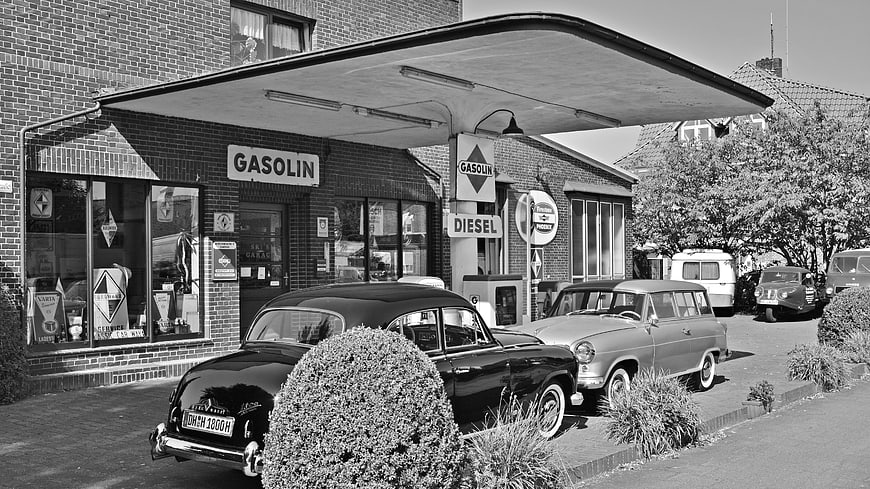 Vintage Black and White Gas Station with Classic Cars