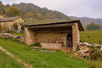 Rustic stone trough and shelter in Italian countryside