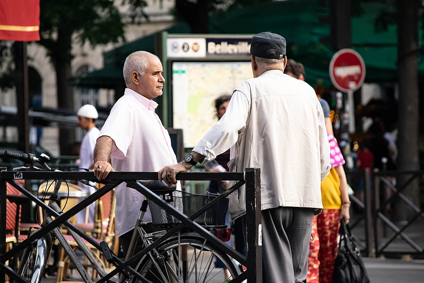 Two Men Talking at Belleville Metro Station Paris