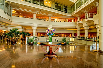 Luxurious hotel lobby with polished floors and floral centerpiece