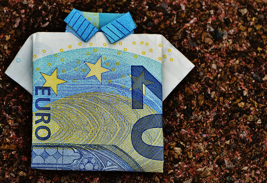Folded 20 Euro Banknote Shirt on Gravel Background