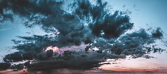 Dramatic Dark Storm Clouds With Pink Sunset Horizon