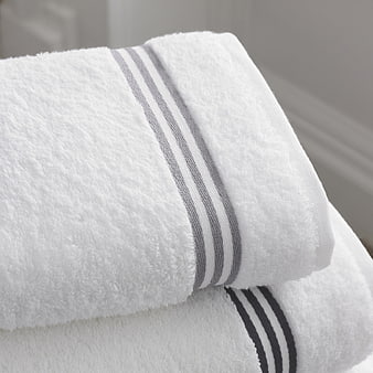 Close-up of folded white towels with gray stripes