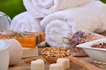 Spa Wellness Still Life With Soap, Bath Salts, And Rolled White Towels