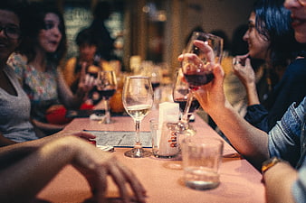Friends enjoying wine and conversation at a restaurant table
