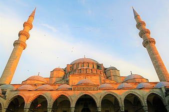 Grand Mosque Architecture with Minarets at Sunset