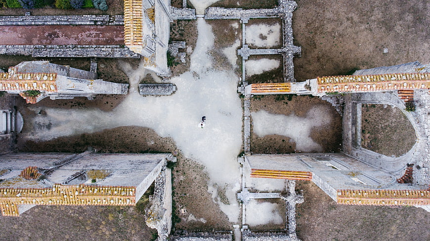 Aerial View of Bride and Groom in Historic Ruins