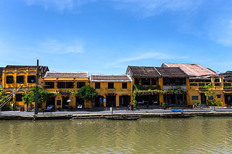 Traditional yellow buildings along Hoi An riverbank