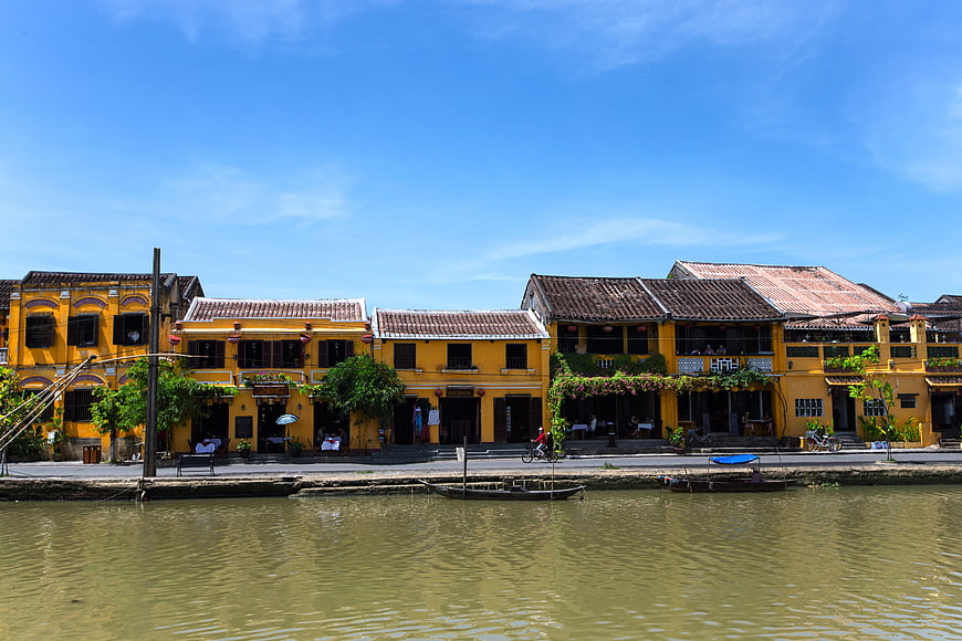 Traditional yellow buildings along Hoi An riverbank