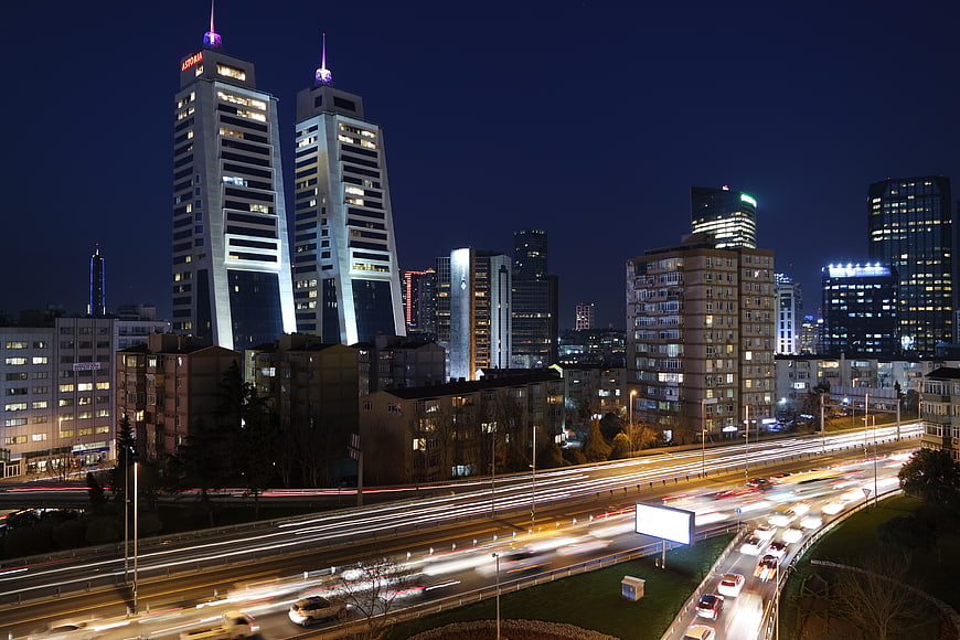 Night cityscape with long exposure highway traffic and skyscrapers