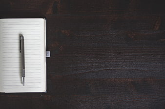 Open Notebook And Pen On Dark Wood Table With Copyspace