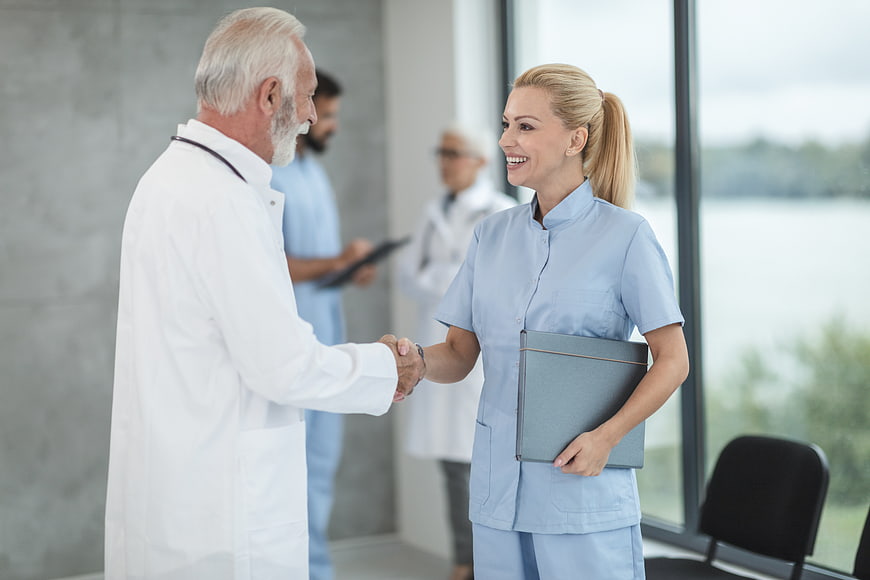 Senior Doctor and Nurse Handshake in Hospital