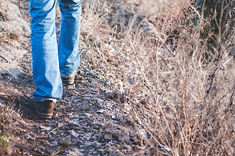 Hiker Walking on Trail in Blue Jeans